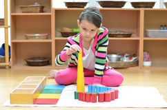little-girl-hand-building-tower-made-montessori-educational-materials-41293925